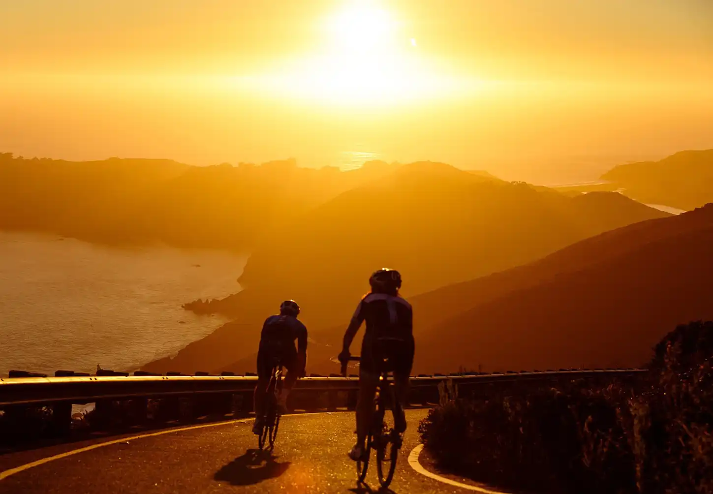 people biking down a hill